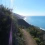 The ocean shines like a gemstone. The land dives headlong into its surface of azure and aquamarine.