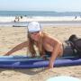 Nina demonstrates proper paddling technique before the lesson. (Chip Scheuer)