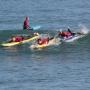 Surf instructor Nina Ke'alohi Dodge, in cap, pushes Pil Nam into a wave. Next to him Bragi Sveinsson paddles hard while Ryan Smith looks on. Chip Scheuer photo.