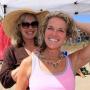 Heidi Nilson trying on her new necklace with the help of Kathy Julian.
