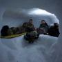Winter adventurers learn to build cozy (and warm!) snow caves.
