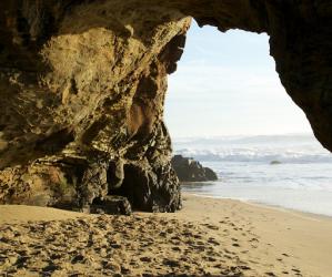 Duck through the hole in the wall at Panther Beach to get to a wide-open expanse of sand. Photo credit: Malikas99.