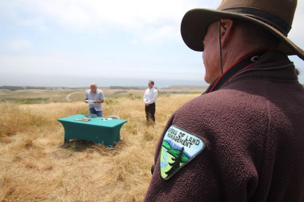 A BLM staff member looks on during the MOU signing ceremony.