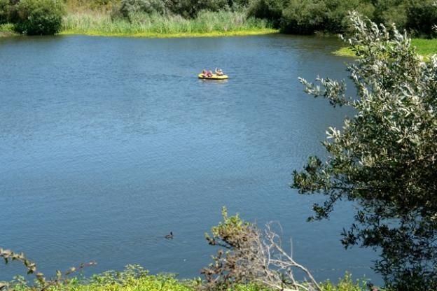 A family in a raft float on the calm waters. Non-motorized watercraft are welcome on Antonelli Pond.