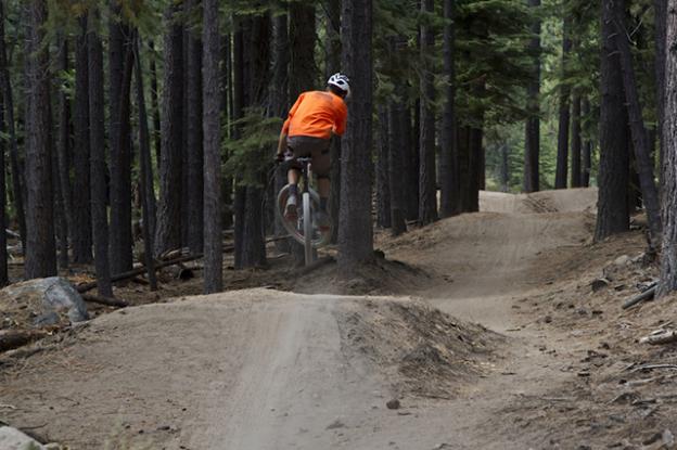 A mountain biker gets airborne. Mountain bikers have long thought sustainable trails might be boring trails. Bell press photo.