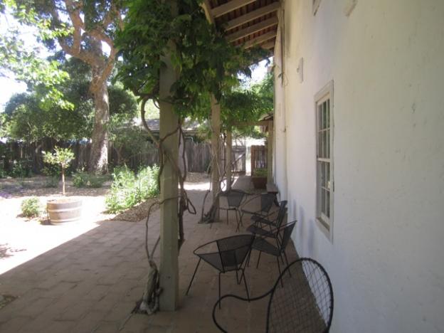 The back porch with its wisteria vines winding up the pillars.