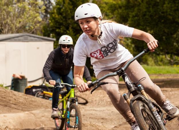 Brittany Bolen (in white) and friend at a Shine Riders pump track clinic. Photo by Clay Ryon.