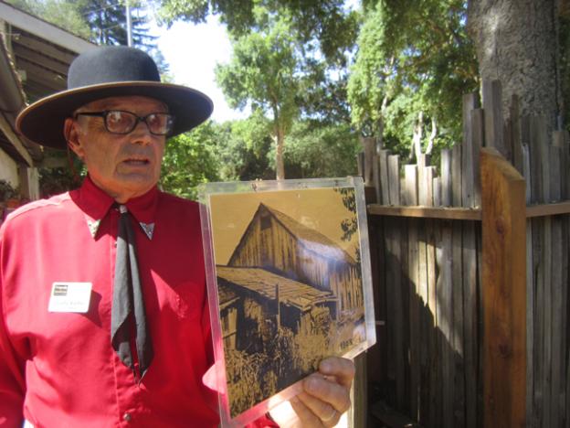 Charlie Kieffer, Friends of Santa Cruz State Parks board member and descendant of the Castro family, with a photo of the Adobe from the 1930s, when it was being used as a barn.