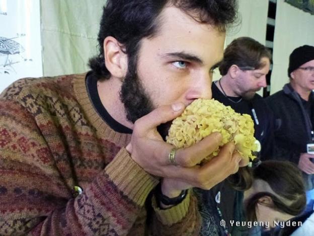 Mmm, fungus: Santa Cruz mycologist Christian Schwarz huffs a shroom. Photo by Yevgeny Nyden.