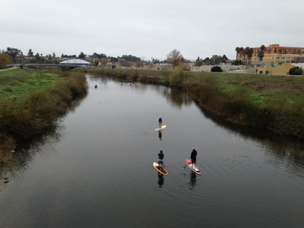 Heading toward the rivermouth. The time was changed to 9am (from 1pm) to coincide with high tide and easier paddling in a low water year. Eileen Cross photo.