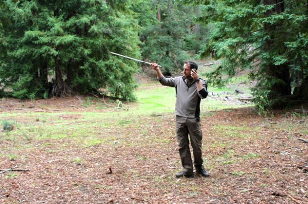 Wildlife biologist Paul Houghtaling listens for faint clicks signaling that a puma is nearby.  Brendan Bane photo.