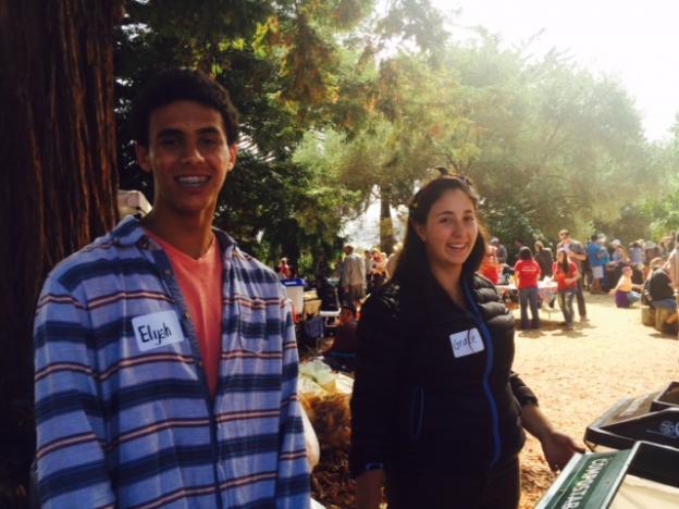 High school-age volunteers Elyah and Grace man the compost/recycling bins.