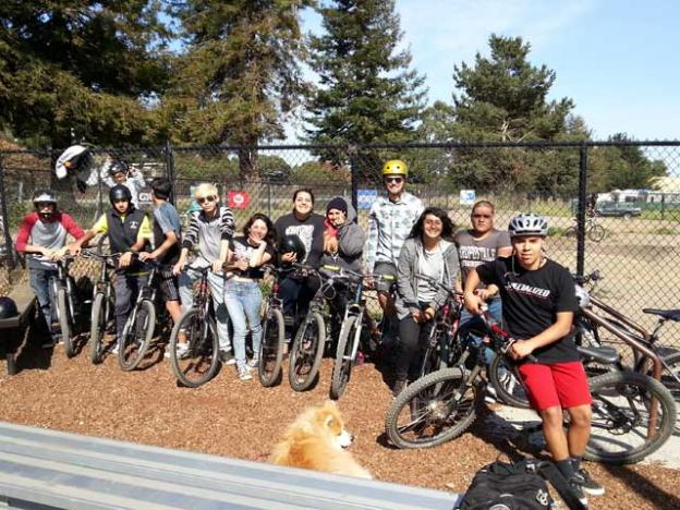 A bunch of smiling PVHS kids at the pump track. There is no pump track in South County. Not yet. Dave Robinson photo.