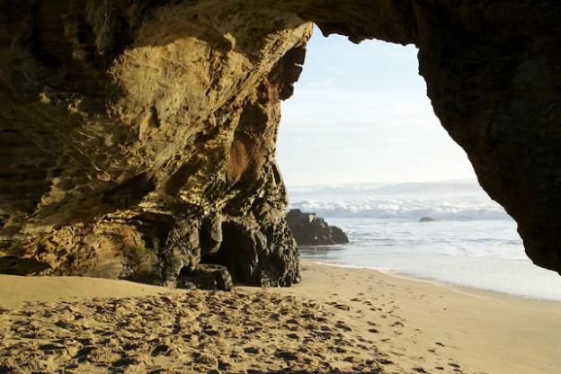 Duck through the hole in the wall at Panther Beach to get to a wide-open expanse of sand. Photo credit: Malikas99.