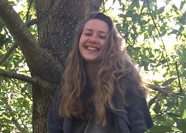 Kelly McCandless, 15, signs copies of her field guide to the Arboretum on Sunday, May 17.