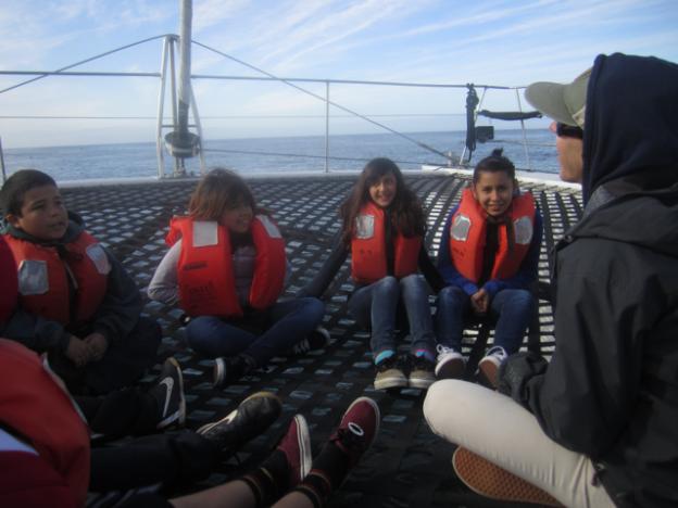 Students listen to Lauren Hanneman talking about marine ecosystems. 