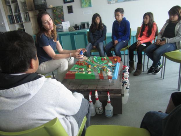 Lauren Hanneman with a 3-D model of a seaside city, which she uses to demonstrate how non point-source pollution gets into the ocean.