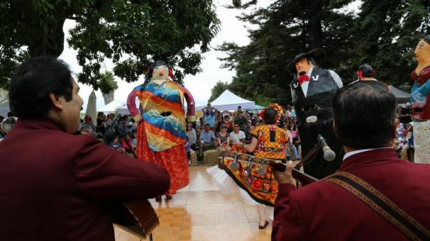 Mariachi players and the mojiganga (giant puppet) dancers are a huge draw at Mole and Mariachis. Photo by Dusty Nelson. 