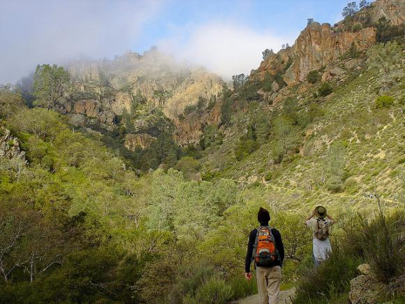 Two hikers look up Condor Gulch Trail at Pinnacles National Park. Photo credit: Miguel Vieira/Creative Commons. 