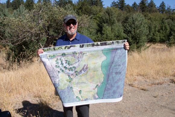 Reed Holderman of Sempervirens Fund displays an artist's rendering of the new Castle Rock entryway. Mike Kahn photo.
